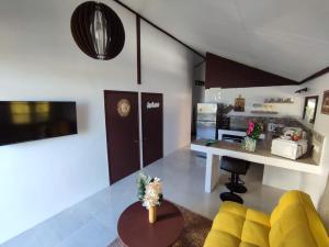 PiraeO'hale Perry的一间带黄色沙发的客厅和一间厨房