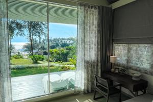 库德岛Shantaa Resort, Kohkood的一间卧室设有大窗户、一张床和一张书桌