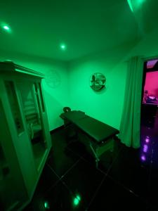 BellencombreAu nid d'amour的绿色的客房配有桌子和镜子