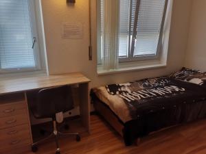 格拉特布鲁格Glatthall的一间卧室配有一张桌子、一张床、一张桌子和窗户。