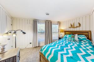 斩魔山Beach House的一间卧室配有一张床、一张书桌和一个窗户。