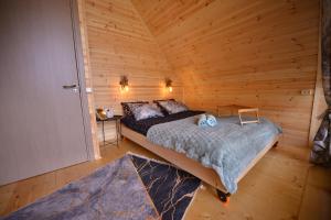 库塔伊西Cottage lima的小木屋内一间卧室,配有一张床