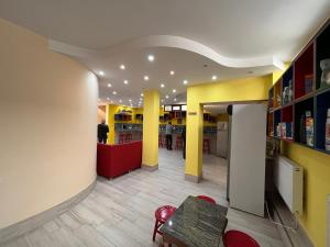 巴统Hostel Jeal的餐厅拥有黄色和黄色的墙壁和桌子