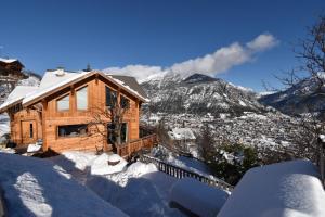 皮圣皮埃尔CHALET SERRE CHEVALIER AVEC VUE EXCEPTIONNELLE的雪中与山间的木屋