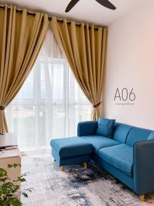 加影SUWAN Guesthouse A06 - 2BR Apartment with Pool Near UKM的客厅设有蓝色的沙发和窗户。