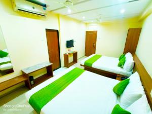 舍地SAI SRUSHTI by NEEM SQUARE的酒店客房设有两张床和电视。