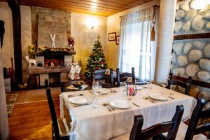 班斯科Velinov Boutique Hotel的一间设有桌子和圣诞树的用餐室