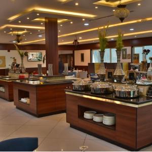 奈季兰The District Hotel Najran的一间提供自助餐的餐厅,展示着各种菜肴