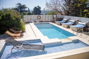 维拉卡洛斯帕兹Casa Alta Hotel Boutique & Spa - Solo Adultos的一个带躺椅的游泳池和一个游泳池