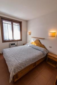 萨帕达RESIDENCE-RESORT BORGO AL SOLE的一间卧室设有一张大床和一个窗户。