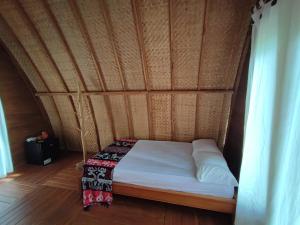 BaingWajonata Sumba的木天花板的客房内的一张床位