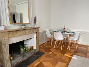 纳沙泰尔V&V CENTRE Neuchatel的客厅设有壁炉、桌子和镜子