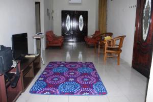 麻坡Homestay Mokde的一间客厅,地板上铺有地毯