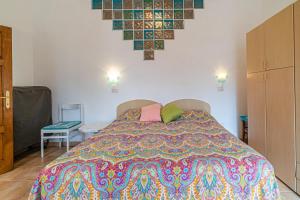 马尔恰纳Casavacanze delle Noci的一间卧室配有一张带彩色床罩的床