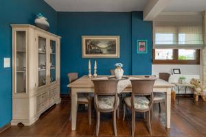 Káto KalésiaCountry House with View的一间拥有蓝色墙壁和桌椅的用餐室