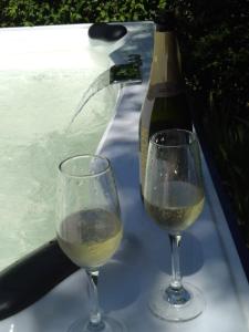 贝尔格拉诺将军镇Casa Simona Villa General Belgrano的两杯热浴盆旁的白葡萄酒