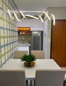 马拉巴Apartamento Concierge Sensacional的厨房配有桌椅和植物