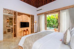 乌布Weda Cita Resort and Spa by Mahaputra的一间卧室设有一张大床和一个大窗户