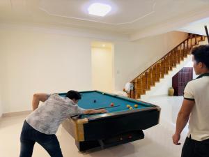Trai MatDalat Eco House的两个男人在房间里打台球