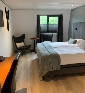 代尔登瓦蓬凡德尔登酒店的卧室配有一张床和一张桌子及椅子