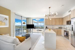 迈阿密Nomada Destination Residences - Quadro的厨房以及带沙发和桌子的客厅。