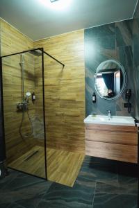 多尔纳-阿里尼Georgia Chalet的带淋浴、盥洗盆和镜子的浴室