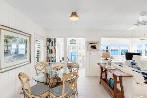 基克罗尼海滩Casa Del Mar的用餐室以及带玻璃桌和椅子的客厅