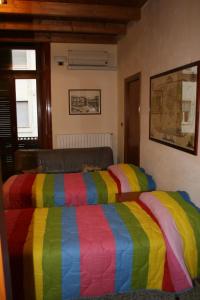福贾JLL Room的一张床上有五颜六色的毯子,放在房间里