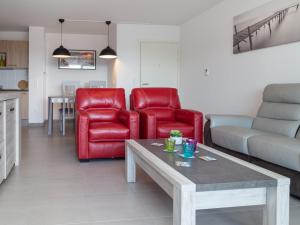 卡布勒通Appartement Capbreton, 3 pièces, 4 personnes - FR-1-239-387的客厅配有2把红色椅子和桌子