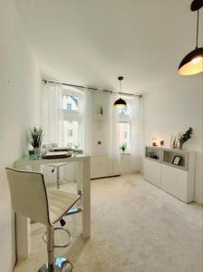 德累斯顿Gemütliches helles Appartement的白色的客房配有书桌和椅子