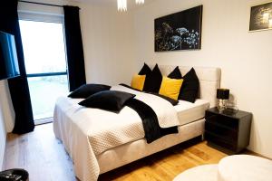 赛特朵夫Ferienwohnung Deluxe Sattendorf的一间卧室配有一张带黄色和黑色枕头的床