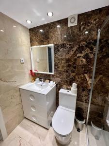 马拉加Apartamentos Prestige Malaga Suites III的浴室配有卫生间、盥洗盆和淋浴。