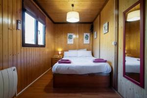Buenache de la SierraCasa Rural La Canadiense Log Cabin的小木屋内一间卧室,配有一张床