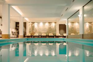 格罗萨尔阿尔特伯斯特酒店的一座配有桌椅的酒店游泳池
