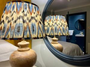 利特尔东海滩宾馆的一间带灯和镜子的卧室