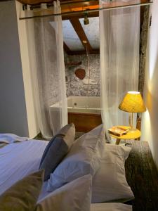 容迪亚伊Café com Morada - Cama e Café的一间卧室配有带窗帘和灯的床