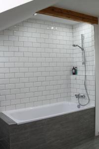 BernauFerienwohnung Stefanko的浴室设有带淋浴的白色浴缸。