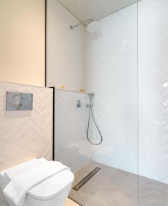 拉纳卡LIV The City Suites ADULTS ONLY的一间带卫生间和玻璃淋浴间的浴室
