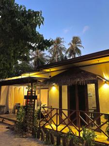 弗里德胡Huvan Inn的一座种植了棕榈树的草屋