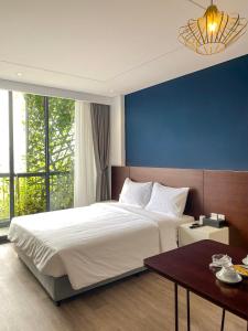 河内A25 Hotel - 18 Nguyễn Hy Quang的一间卧室设有一张蓝色墙壁的大床
