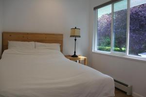 萨里Ocean Park B&B的卧室配有白色的床和窗户。