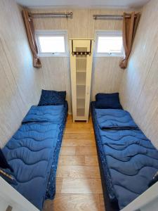 海牙KD 866 - Vakantiepark Kijkduin的带2扇窗户的小客房内的2张床