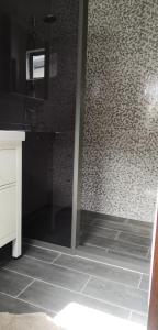 帕拉马里博Bij BRAKKE的带淋浴的浴室,铺有瓷砖地板。