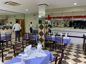 努瓦克肖特Hotel Hayatt的一间设有蓝色桌椅的餐厅和一间厨房