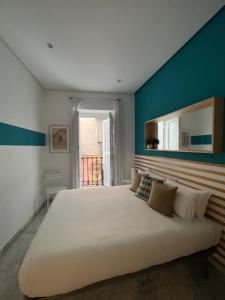 塞维利亚Iberflat Fabiola的一间卧室设有一张蓝色墙壁的大床