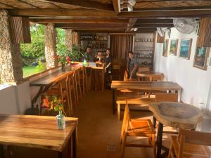 安达Blue Raven Resort的餐厅设有木桌,客人坐在桌子旁