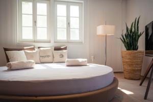 哈默尔堡Neumühle Resort & Spa的卧室配有一张带白色床单和枕头的大床。