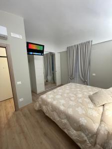 圣萨尔沃Appartamento Totò的卧室配有一张床,墙上配有电视。