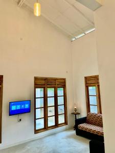 坦加拉ALOHA Second Home的客厅配有沙发和墙上的电视