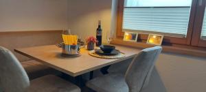 普范德斯Apart Antonius的餐桌、一瓶葡萄酒和椅子